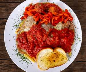 Parmigiana Platter: a little of everything, chicken, veal, eggplant, meatball, roasted red peppers and provolone over pasta